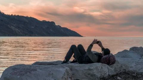 Relax at sunset lying on the rocks 写真素材
