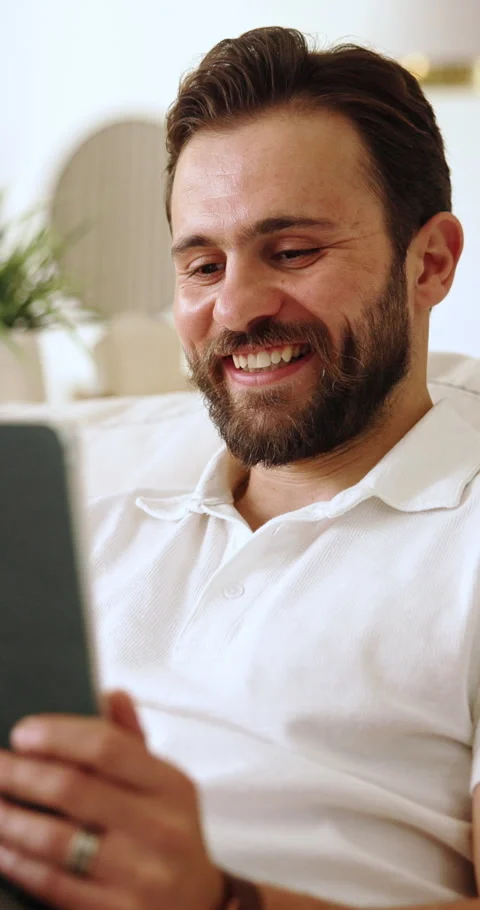 Relax, tablet and man on sofa in home for reading blog on saving, investment or Stock Footage 337689898