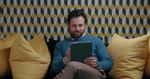 Relax, tablet and web design with business man in break room of office for Stock Footage 316458931