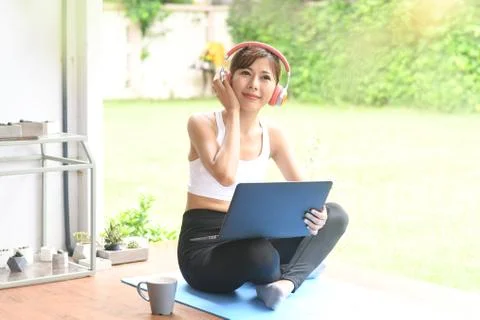Relax on vacation with music on a computer and exercise. Stock Photos