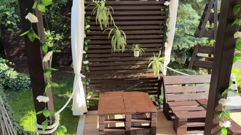 A relaxation area in the garden in front of the house, a wooden veranda, a .. Stock Footage 314485128