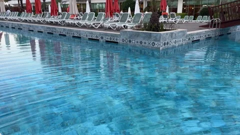 Relaxation Area Inside the Pool with umbrellas and sun beds Stock Footage 297966532