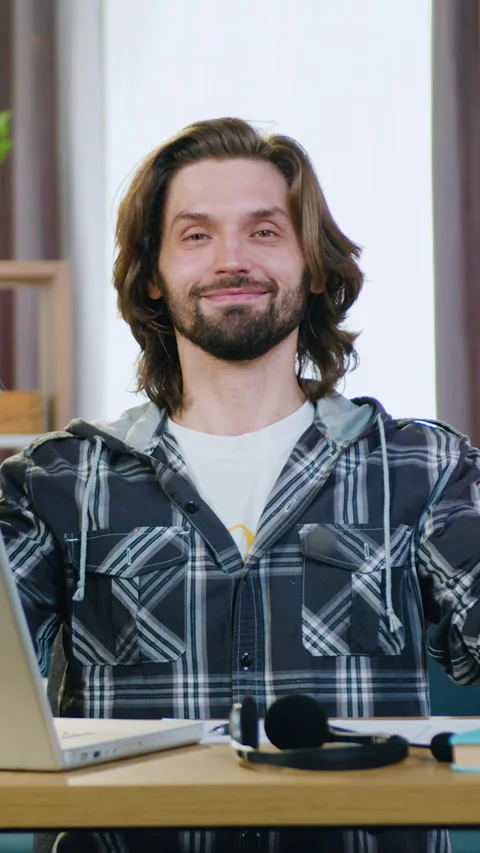 Relaxation concept where handsome relaxed positive 30-aged bearded guy sitting a Stock Footage 328941649