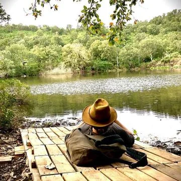 Relaxation at the edge of a river in front of a forest Stock Photos