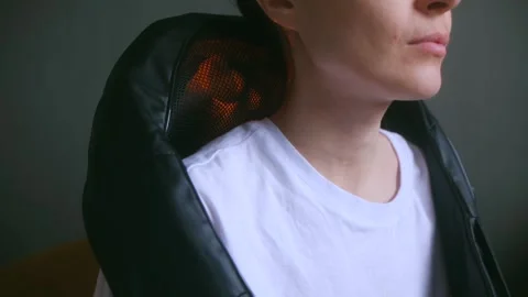 Relaxation through heated neck and shoulder massager therapy Stock Footage 312982560