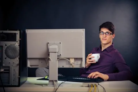 Relaxed Admin At His Desk Stock-Fotos