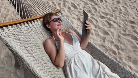 Relaxed Beachside Hammock Tablet Browsing Stock Footage 263337835