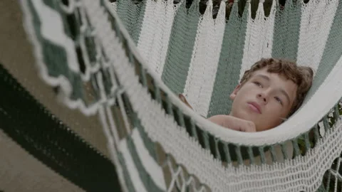 Relaxed boy lying in striped hammock Stock-Footage 300582040