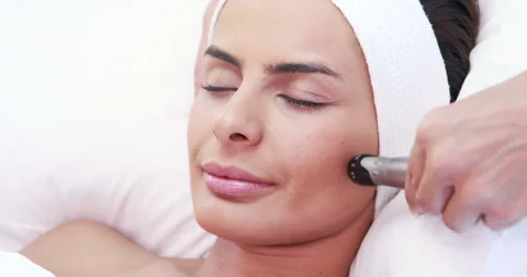 Relaxed brunette having facial treatment Stock Footage