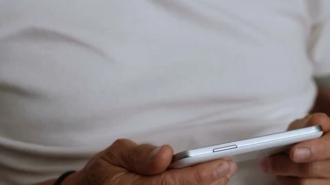 Relaxed charming mature man using his smartphone, portrait Stock Footage 77736880