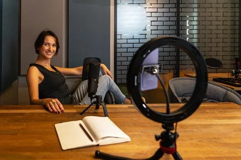 Relaxed content creator resting after recording session in modern studio Stock Photos
