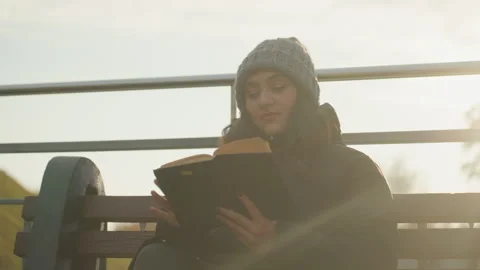 Relaxed female reader with soft evening background and gentle light. Peaceful Stock Footage 345154505