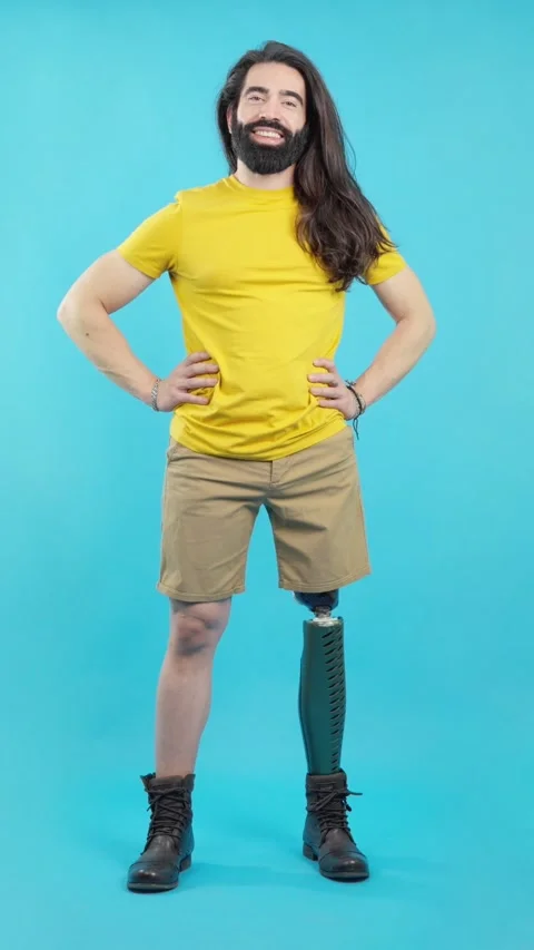 Relaxed man with a leg prosthesis standing smiling at camera Stock Footage 239262873