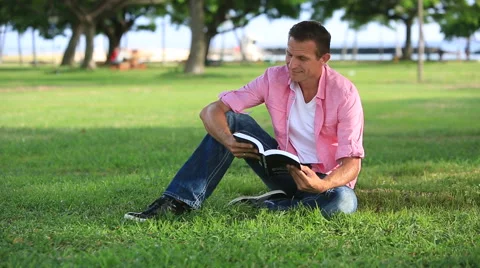 Relaxed Man Reading Book In The Park Stock Footage 55583961