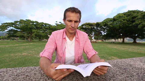 Relaxed Man Reading Book In The Park Stock Footage 55627544