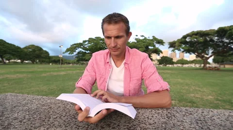 Relaxed Man Reading Book In The Park Stock Footage 55630287