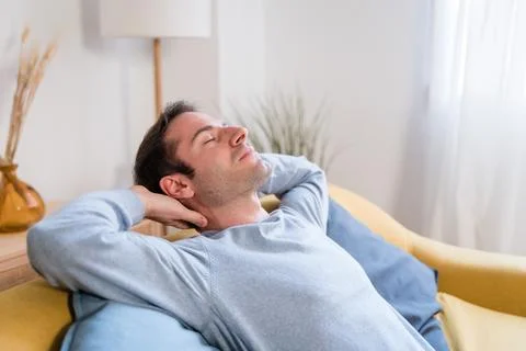 Relaxed man sleeping on sofa Foto stock
