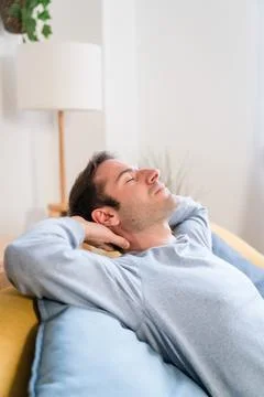Relaxed man sleeping on sofa Stock Photos