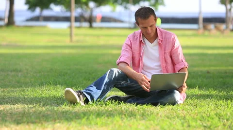 Relaxed Man Using computer In The Park Stock Footage 55617941