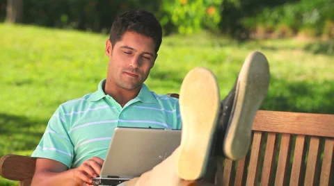 Relaxed man working on a laptop Stock Footage 2909695