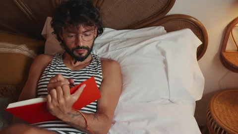 Relaxed Man Writing Journal in Bed Stock Footage 339603089