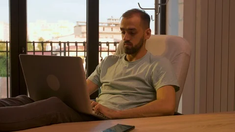 Relaxed manager in his office typing on the laptop Stock Footage 114315937