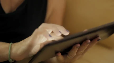 Relaxed middle aged woman using tablet PC on couch Stock Footage 32361604