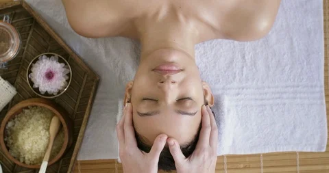 Relaxed mixed race woman at spa facial Stock Footage