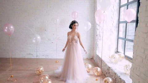Relaxed model works in a gentle airy long dress in pink and purple colors, poses Stock Footage 100193582