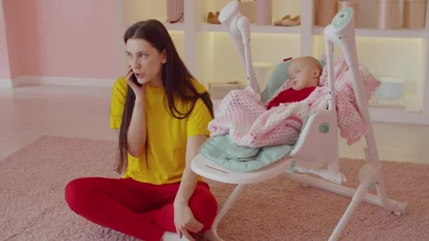 Relaxed mother chatting on phone while Stock Video Pond5