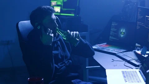 Relaxed programmer working with data codes on multiple displays and drinking 스톡 동영상 108825816