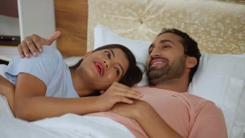 Relaxed romantic Indian couples talking together by hugging each other at Vidéo 264763966
