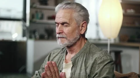 Relaxed senior gray haired man meditate and breathe slowly while make yoga Stock Footage 253513808