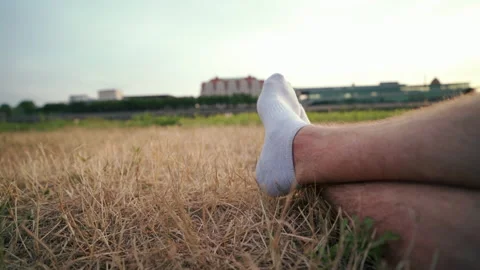 Relaxed sitting in yellow grass in summer at the river Stock Footage 204097401