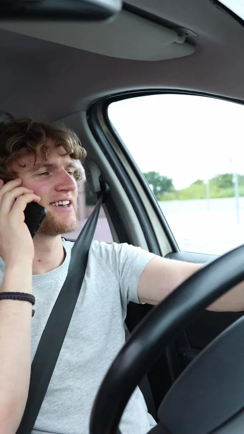 Relaxed smiling driver enjoys a cheerful phone conversation on the road Stock Footage 342921040
