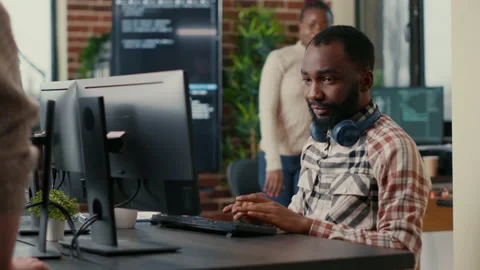 Relaxed software developer wearing wireless headphones smiling working looking Stock Footage 168235200