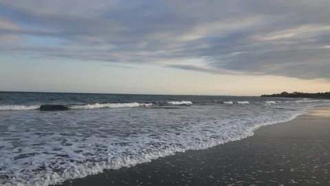 Relaxed Stroll on Keramas Black Beach, Bali at Sunset Stock Footage 340399249