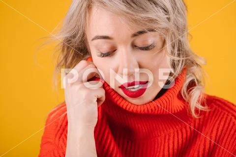 Relaxed thoughtful romantic blobde woman portrait in red jumper. Yellow Stock Photos