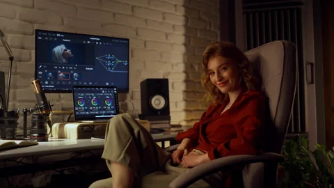 Relaxed woman game developer working on design using her personal computer and 動画素材 247448368