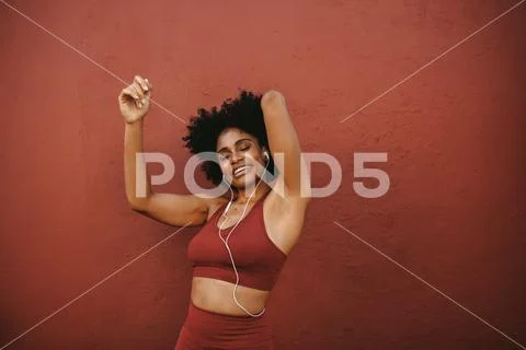 Relaxed woman listening to music after workout Stock Photos
