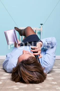 Relaxed woman lying down chatting on phone Stock Photos