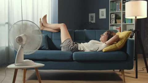 Relaxed woman lying down on the sofa during summer time Stock Footage 150847224