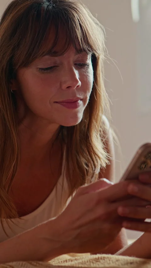 Relaxed Woman Using Smartphone in Bed at Home Stock Footage 333151885