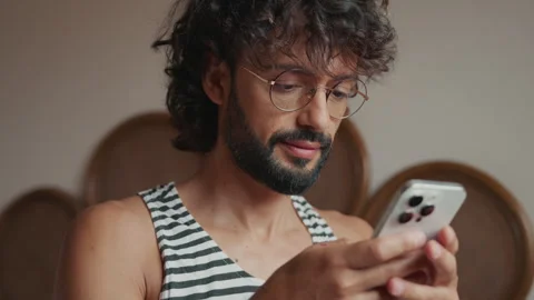 Relaxed Young Man Engaged With Smartphone At Home Stock Footage 332257919