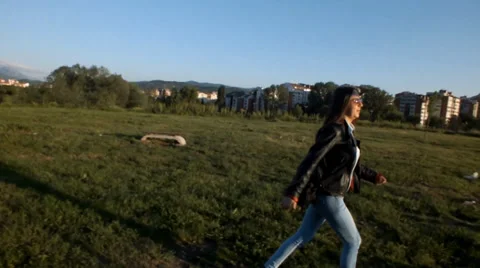 Relaxing after a long learning in the park, a cute girl who enjoys the sun set a Stockbeeldmateriaal 37848651