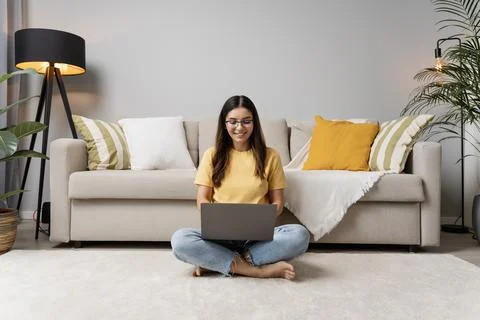 Relaxing ambience for work and study. Beautiful woman typing on laptop on the Stock Photos