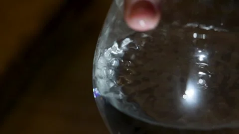 A relaxing and satisfying pattern emerges from the water as a woman runs her Stock Footage 297677065