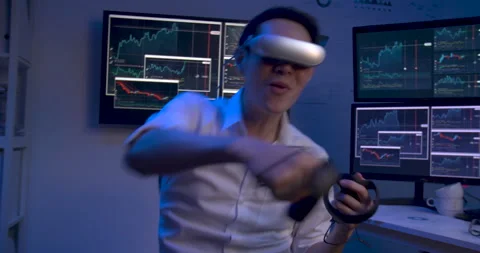 Relaxing asian man is using VR playing game while working hard at late night. Video stock 140525136