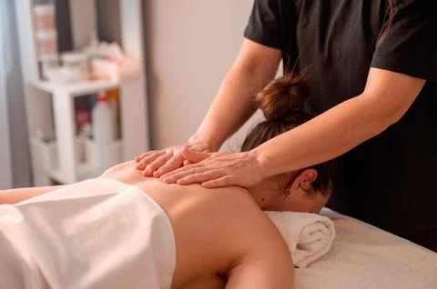A relaxing back and neck massage in a salon setting Stock Photos