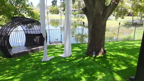 Relaxing Backyard with Hammock Swing Lounge Pod Overlooking Lake in Miramar, FL Stock Footage 311340079
